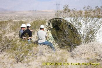 Workers inspect fallen blade