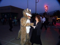 Coyote mascot dances with ECM editor Miriam Raftery