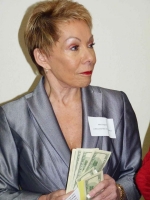 Chamber president Mary England gives away cash in 50/50 drawing