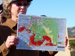 Donna Tisdale displays map of high fire danger areas along Powerlink route
